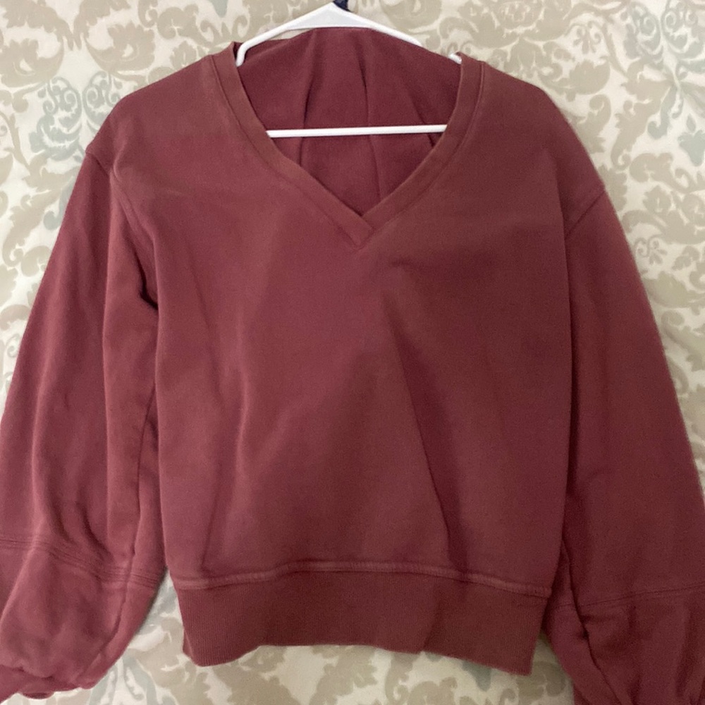 Burgundy v-neck sweatshirt.